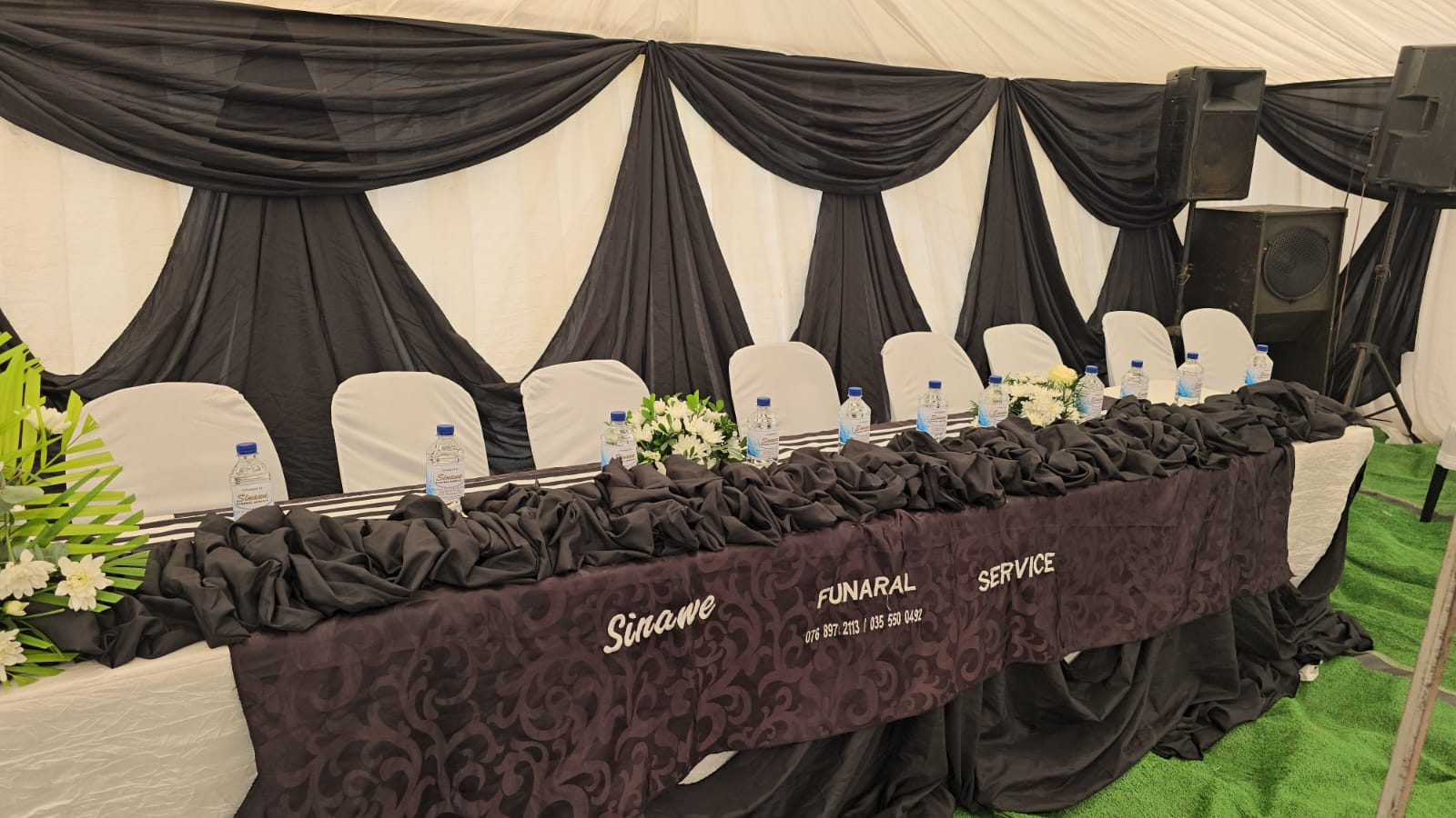 Black-and-white draped head table at a Sinawee service